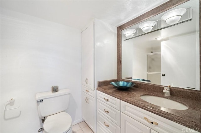 24055 Paseo Del Lago Unit 1206, Laguna Woods, CA 92637 - bathroom featuring toilet, vanity, an enclosed shower, and tile patterned floors