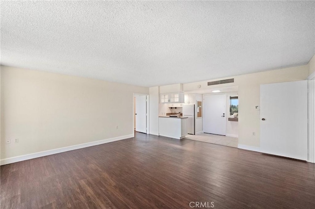 24055 Paseo Del Lago Unit 1206, Laguna Woods, CA 92637 - unfurnished living room featuring wood finished floors, a textured ceiling, and baseboards