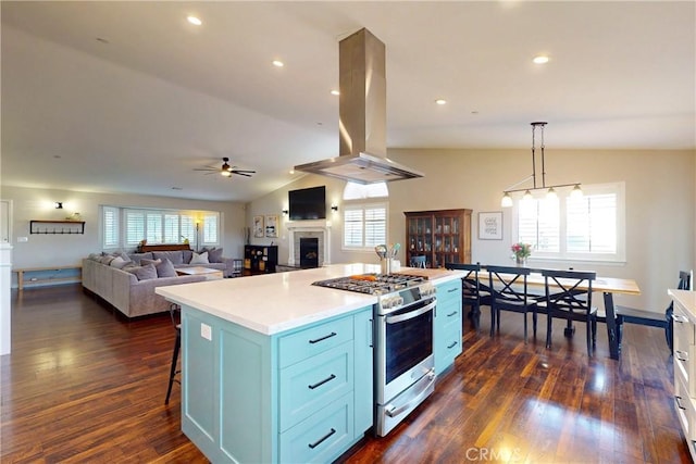 200 Cyclone St, Nipomo, CA 93444 - kitchen featuring stainless steel range with gas cooktop, island exhaust hood, ceiling fan, dark wood-style flooring, and a fireplace