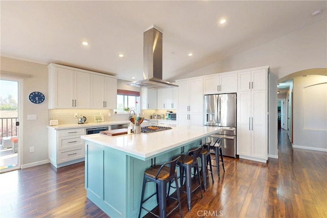 200 Cyclone St, Nipomo, CA 93444 - kitchen with stainless steel refrigerator with ice dispenser, island exhaust hood, a kitchen island, dark wood-style flooring, and arched walkways