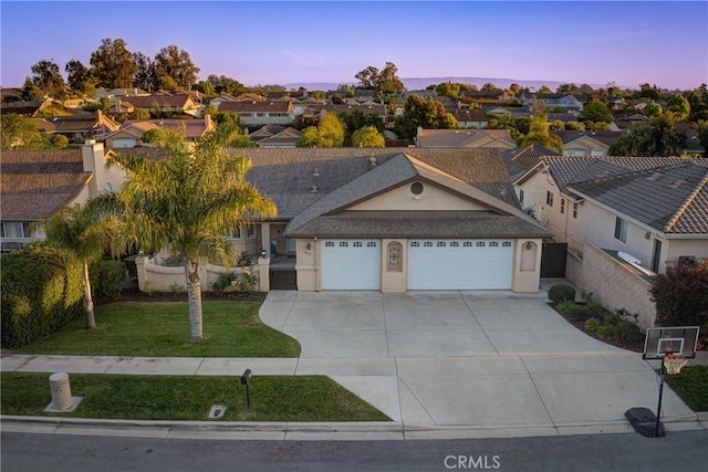 200 Cyclone St, Nipomo, CA 93444 - ranch-style house featuring an attached garage, driveway, a front yard, a residential view, and stucco siding