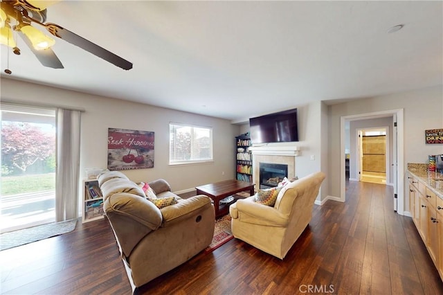 200 Cyclone St, Nipomo, CA 93444 - living area featuring dark wood-style floors, a fireplace, a ceiling fan, and baseboards
