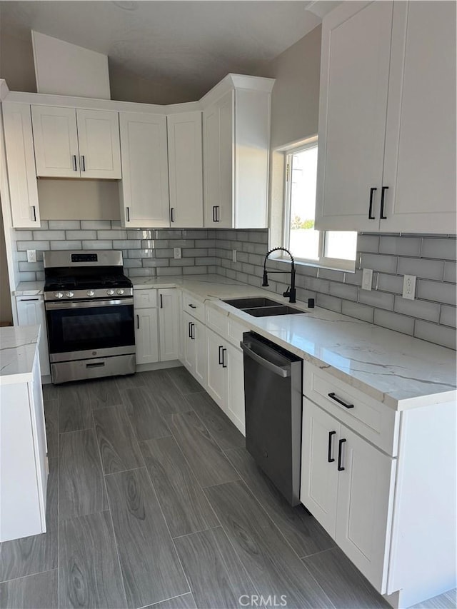 6693 Banyan Ave, Hesperia, CA 92345 - kitchen featuring stainless steel appliances, a sink, white cabinets, and decorative backsplash