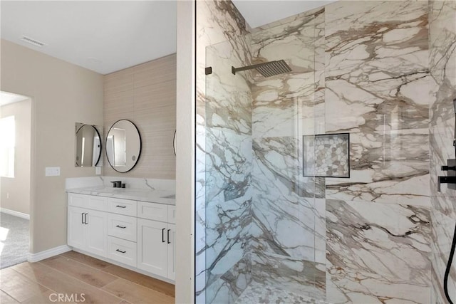 6693 Banyan Ave, Hesperia, CA 92345 - bathroom with double vanity, a marble finish shower, and wood finished floors