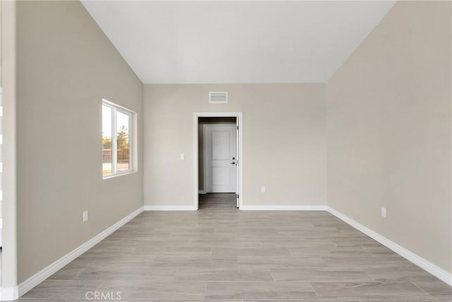 6693 Banyan Ave, Hesperia, CA 92345 - empty room with baseboards, vaulted ceiling, and light wood-style floors
