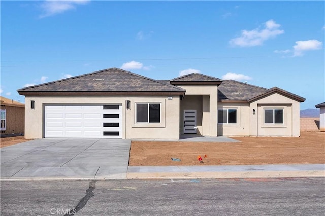 6693 Banyan Ave, Hesperia, CA 92345 - view of front of property featuring concrete driveway, stucco siding, and an attached garage