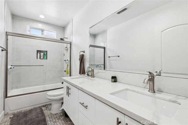 2806 Cudahy St, Huntington Park, CA 90255 - full bath with toilet, double vanity, shower / bath combination with glass door, tile patterned floors, and recessed lighting