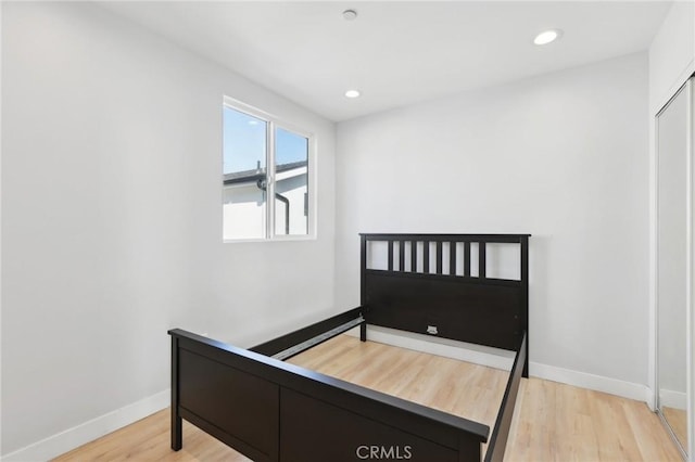 2806 Cudahy St, Huntington Park, CA 90255 - bedroom with light wood-style flooring, baseboards, and recessed lighting