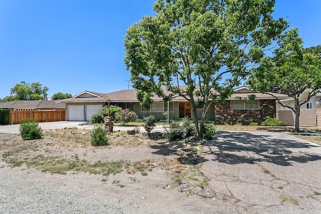 13321 Prospect Ave, North Tustin, CA 92705 - ranch-style house featuring driveway, an attached garage, and stone siding