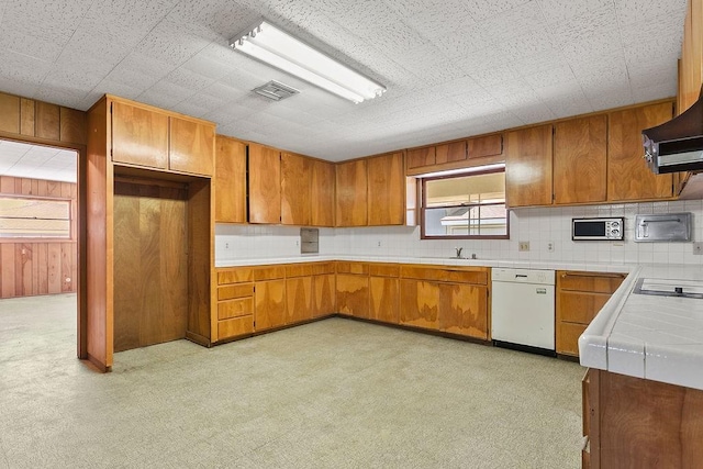 13321 Prospect Ave, North Tustin, CA 92705 - kitchen featuring white dishwasher, brown cabinets, tile counters, a sink, and tasteful backsplash