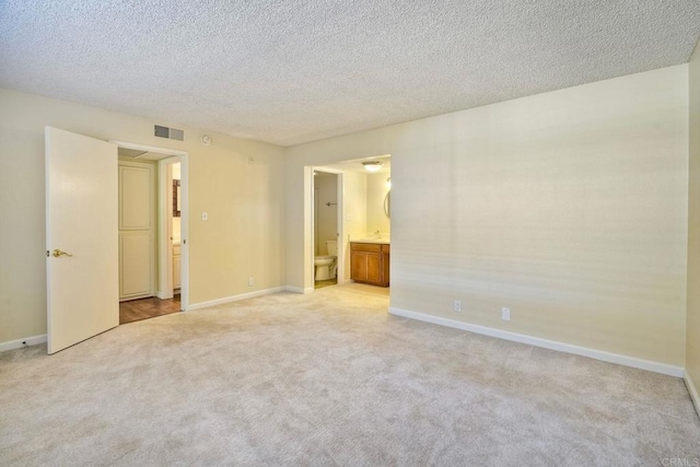 2564 Navarra Dr Unit 115, Carlsbad, CA 92009 - spare room with light colored carpet, baseboards, and a textured ceiling