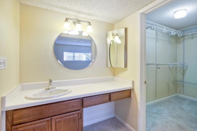 2564 Navarra Dr Unit 115, Carlsbad, CA 92009 - bathroom with a textured ceiling and vanity
