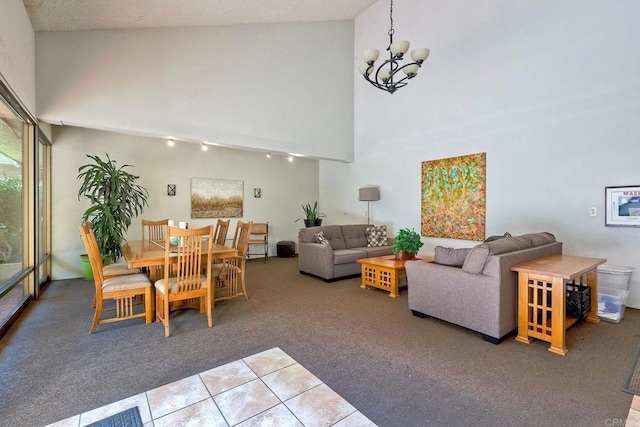 2564 Navarra Dr Unit 115, Carlsbad, CA 92009 - dining room featuring carpet flooring, a chandelier, track lighting, a high ceiling, and tile patterned floors