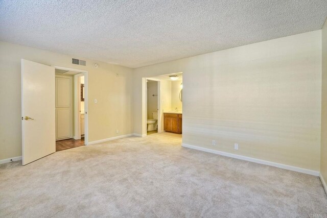 2564 Navarra Dr Unit 115, Carlsbad, CA 92009 - empty room with light colored carpet and a textured ceiling