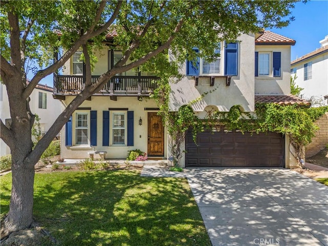 26556 Beecher Ln, Stevenson Ranch, CA 91381 - mediterranean / spanish-style home with a balcony, an attached garage, stucco siding, driveway, and a tiled roof