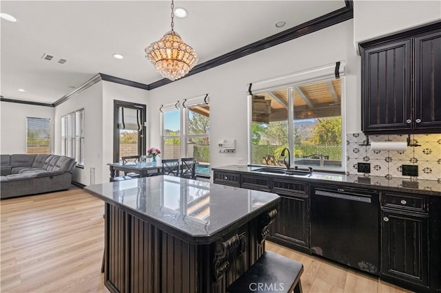 26556 Beecher Ln, Stevenson Ranch, CA 91381 - kitchen featuring black dishwasher, a sink, light wood-style floors, ornamental molding, and dark stone countertops