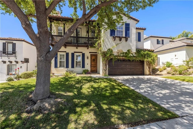 26556 Beecher Ln, Stevenson Ranch, CA 91381 - mediterranean / spanish-style home featuring a balcony, an attached garage, driveway, a front yard, and stucco siding