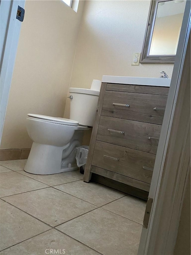 5429 Encelia Dr Unit 29, Palms, CA 92277 - half bath featuring toilet, vanity, tile patterned flooring, and baseboards