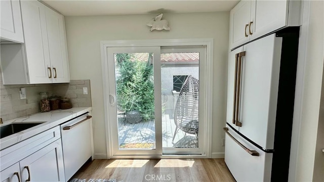 11467 Tampa Ave Unit 154, Porter Ranch, CA 91326 - doorway with light wood-style floors and baseboards