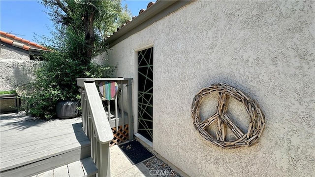 11467 Tampa Ave Unit 154, Porter Ranch, CA 91326 - view of exterior entry featuring stucco siding and a deck