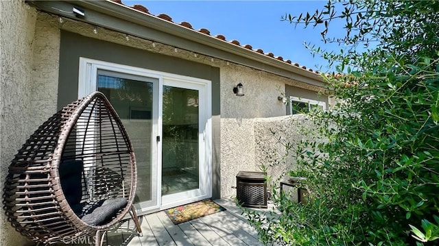 11467 Tampa Ave Unit 154, Porter Ranch, CA 91326 - entrance to property featuring stucco siding, a deck, and a tiled roof