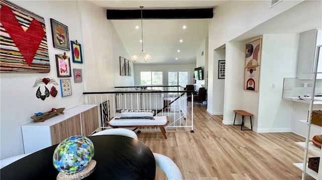 11467 Tampa Ave Unit 154, Porter Ranch, CA 91326 - hall with light wood-style flooring, beamed ceiling, baseboards, a chandelier, and an upstairs landing