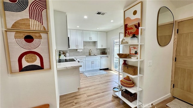11467 Tampa Ave Unit 154, Porter Ranch, CA 91326 - kitchen featuring stainless steel dishwasher, open shelves, light wood-style floors, a sink, and decorative backsplash