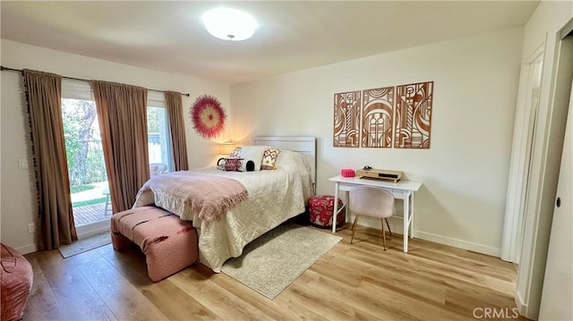 11467 Tampa Ave Unit 154, Porter Ranch, CA 91326 - bedroom featuring access to outside, light wood-style flooring, and baseboards