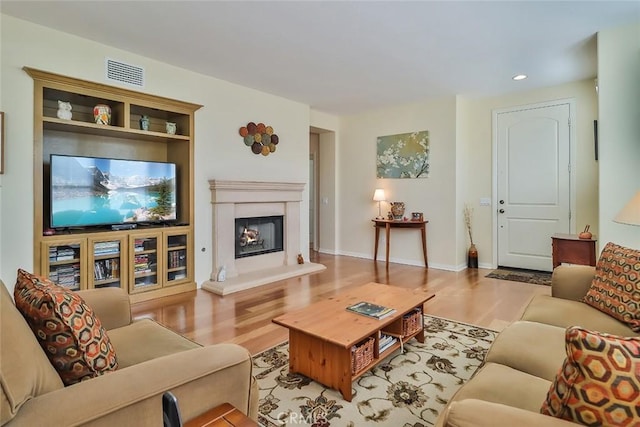 3607 Cascara Ct, Simi Valley, CA 93065 - living room with wood finished floors, a lit fireplace, recessed lighting, and baseboards