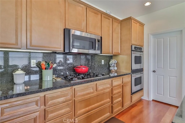 3607 Cascara Ct, Simi Valley, CA 93065 - kitchen featuring stainless steel appliances, backsplash, light wood-style floors, dark stone counters, and recessed lighting