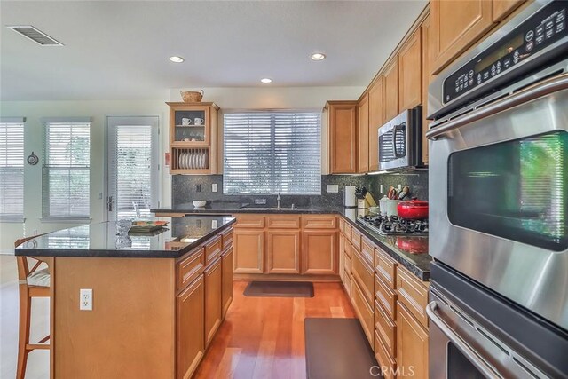 3607 Cascara Ct, Simi Valley, CA 93065 - kitchen featuring appliances with stainless steel finishes, plenty of natural light, light wood-style flooring, decorative backsplash, and recessed lighting