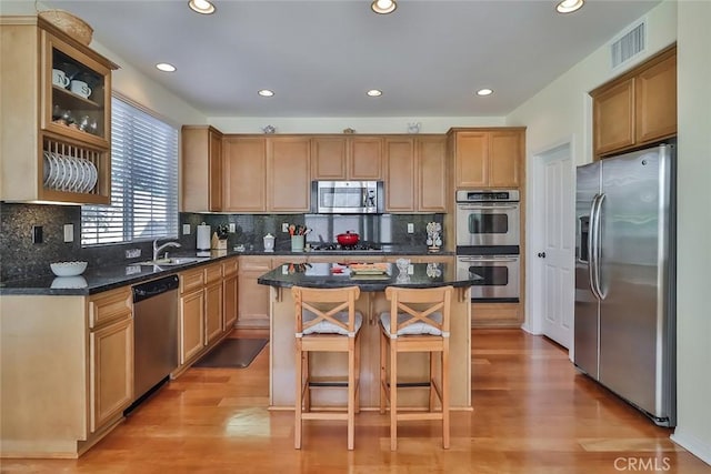 3607 Cascara Ct, Simi Valley, CA 93065 - kitchen with appliances with stainless steel finishes, a breakfast bar, recessed lighting, a center island, and light wood-style floors