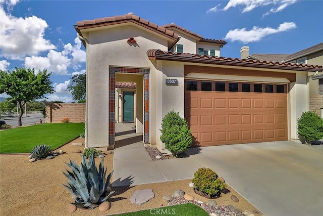 3607 Cascara Ct, Simi Valley, CA 93065 - mediterranean / spanish-style house with an attached garage, stucco siding, concrete driveway, and a tile roof
