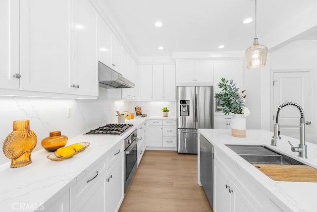 61 Jade Flower, Irvine, CA 92620 - kitchen featuring stainless steel appliances, a sink, under cabinet range hood, white cabinetry, and recessed lighting