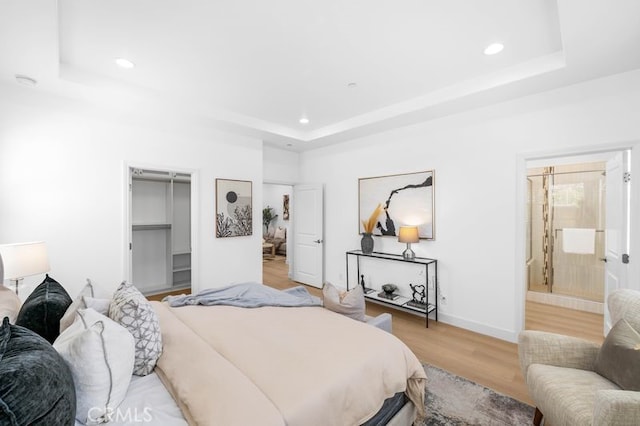 61 Jade Flower, Irvine, CA 92620 - bedroom with a raised ceiling, light wood-type flooring, recessed lighting, a walk in closet, and baseboards