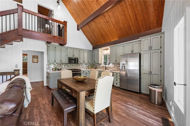 635 Grass Valley Rd, Lake Arrowhead, CA 92352 - dining space featuring high vaulted ceiling, dark wood finished floors, stairway, and wood ceiling with exposed beams
