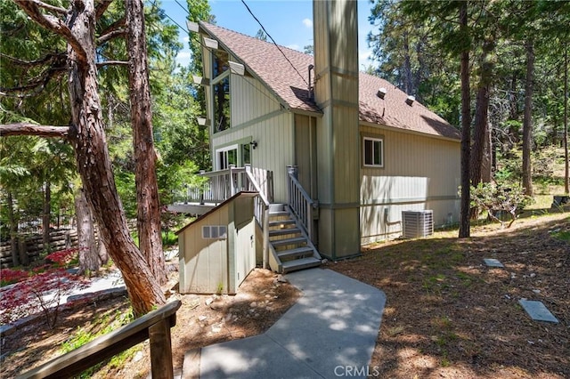 635 Grass Valley Rd, Lake Arrowhead, CA 92352 - back of house with roof with shingles and central AC
