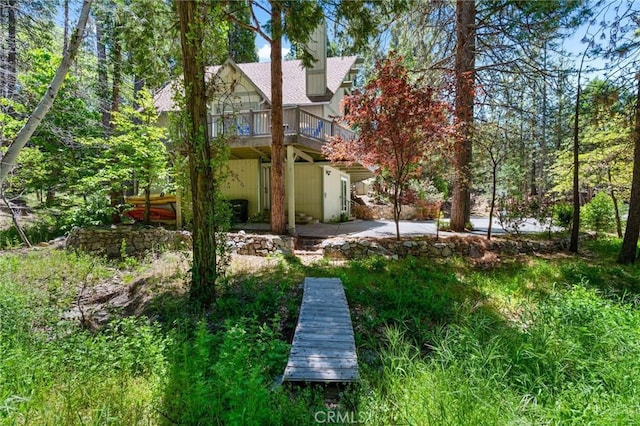635 Grass Valley Rd, Lake Arrowhead, CA 92352 - back of property with a deck and a chimney