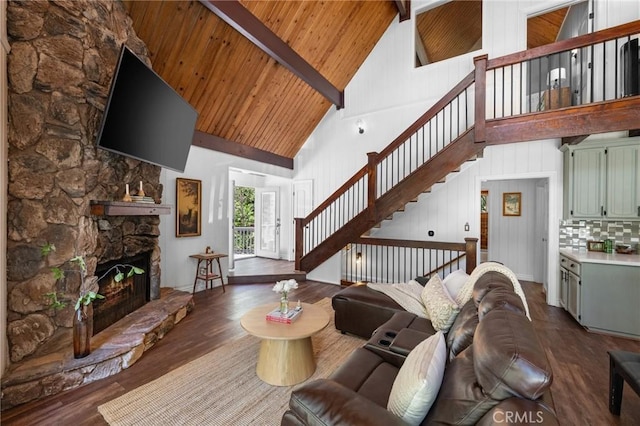 635 Grass Valley Rd, Lake Arrowhead, CA 92352 - living area featuring high vaulted ceiling, stairway, wood ceiling with exposed beams, a stone fireplace, and dark wood finished floors