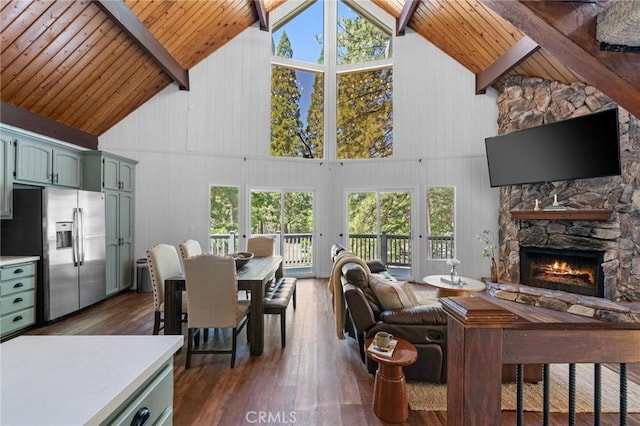 635 Grass Valley Rd, Lake Arrowhead, CA 92352 - living area with high vaulted ceiling, wood ceiling with exposed beams, plenty of natural light, a stone fireplace, and dark wood finished floors