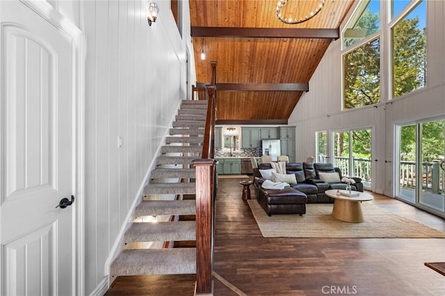 635 Grass Valley Rd, Lake Arrowhead, CA 92352 - living area with high vaulted ceiling, wood finished floors, wooden ceiling with exposed beams, stairs, and wood walls