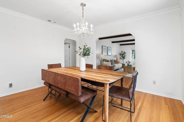 1675 N El Molino Ave, Pasadena, CA 91104 - dining area with arched walkways, light wood-type flooring, a chandelier, baseboards, and crown molding