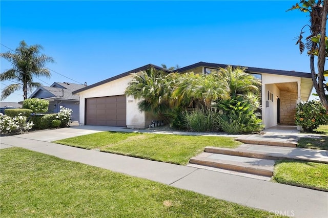 33292 Bremerton St, Dana Point, CA 92629 - view of front of home featuring stucco siding, a front lawn, concrete driveway, an attached garage, and stone siding