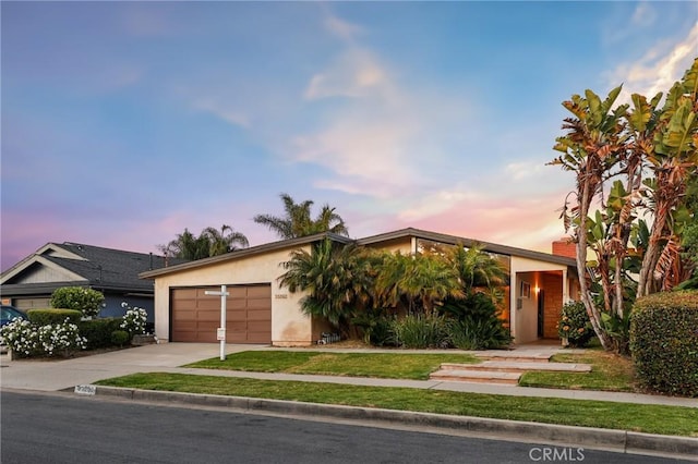 33292 Bremerton St, Dana Point, CA 92629 - view of front of house with concrete driveway, a garage, stucco siding, and a yard