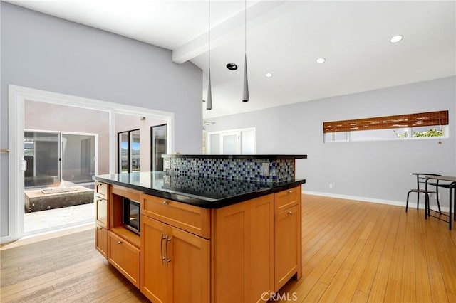 33292 Bremerton St, Dana Point, CA 92629 - kitchen with dark countertops, light wood-style flooring, recessed lighting, a kitchen island, and baseboards