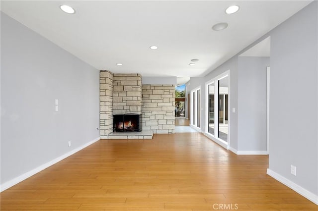 33292 Bremerton St, Dana Point, CA 92629 - unfurnished living room featuring a stone fireplace, baseboards, light wood finished floors, and recessed lighting