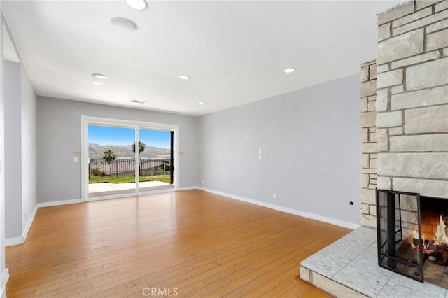 33292 Bremerton St, Dana Point, CA 92629 - unfurnished living room featuring baseboards, a stone fireplace, wood finished floors, and recessed lighting
