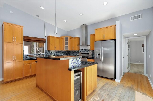 33292 Bremerton St, Dana Point, CA 92629 - kitchen featuring appliances with stainless steel finishes, wall chimney range hood, wine cooler, a center island, and light wood-type flooring