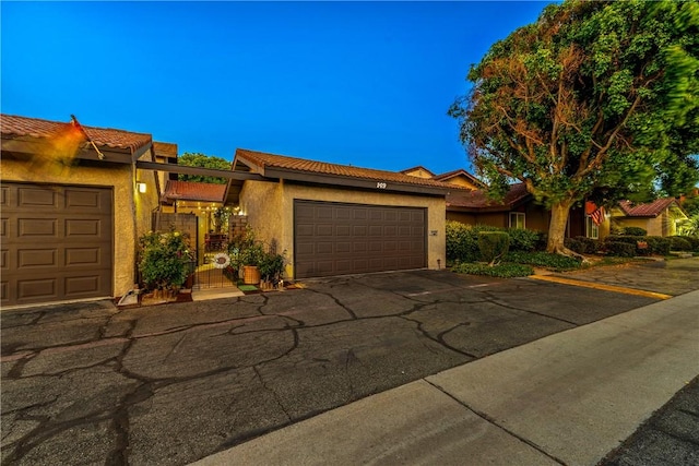 149 S Hollenbeck Ave, Covina, CA 91723 - view of front of property featuring stucco siding, a tiled roof, a garage, and asphalt driveway