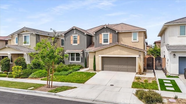 4852 S Jordan Ave, Ontario, CA 91762 - view of front of house featuring a gate, an attached garage, board and batten siding, driveway, and stucco siding